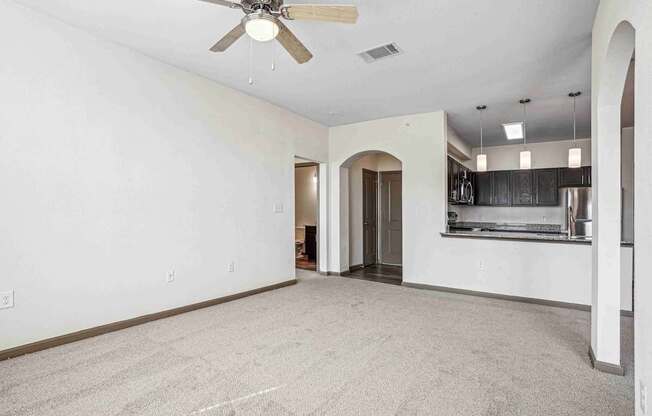 1 & 2-Bedroom Apartments for Rent in Bentonville, AR – Parc at Bentonville – Living Room with ceiling fan and plush carpeting