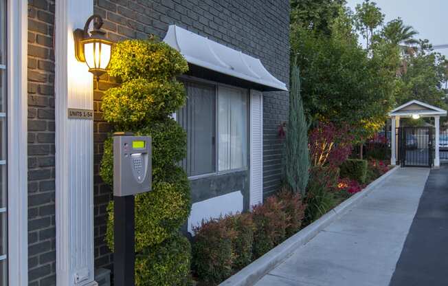 a mailbox on a sidewalk in front of a brick building