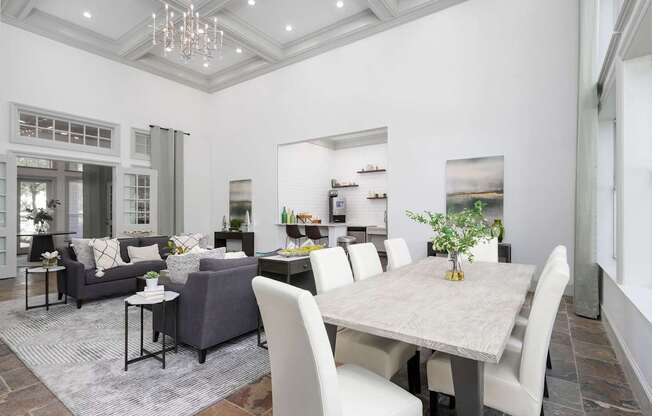 A dining room with a table and chairs.
