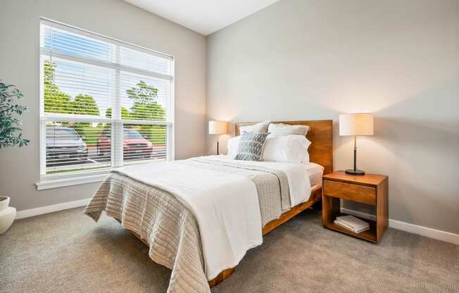 a bedroom with a large window and a bed