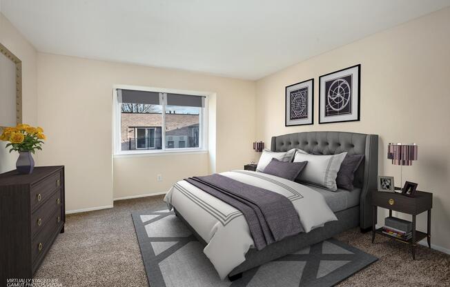 Spectacular model bedroom with carpeted flooring and sizable window at Franklin Commons apartments for rent in Bensalem, PA