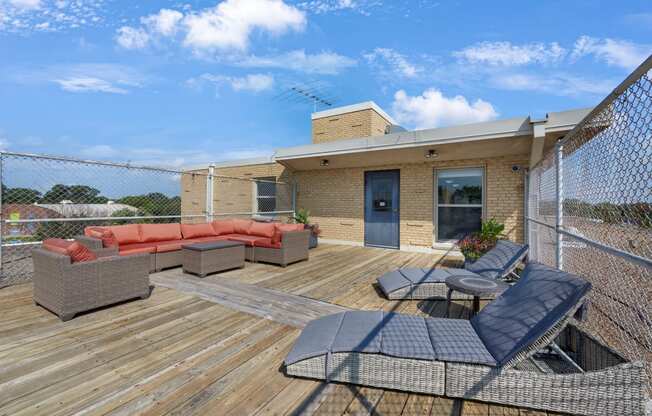 the deck of a home with furniture and a fence