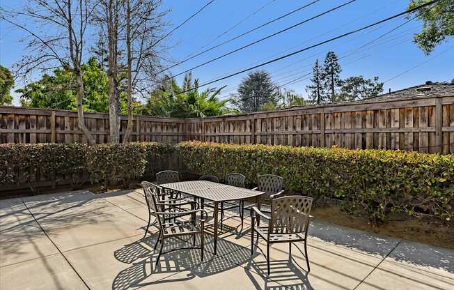 A table and chairs are set up on a patio.