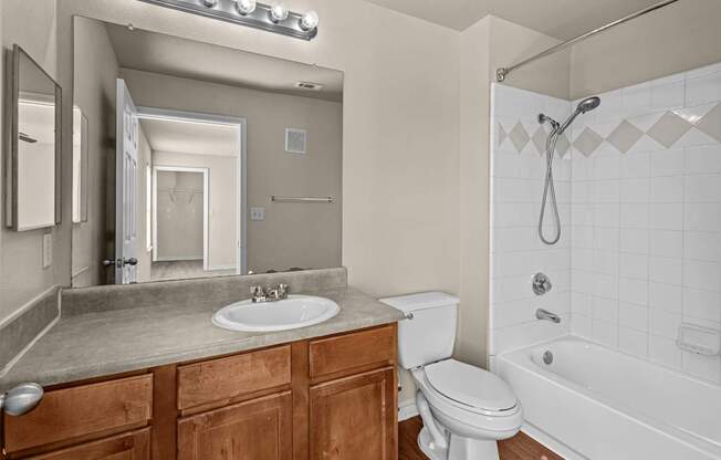 A bathroom with a white toilet, sink, and bathtub.