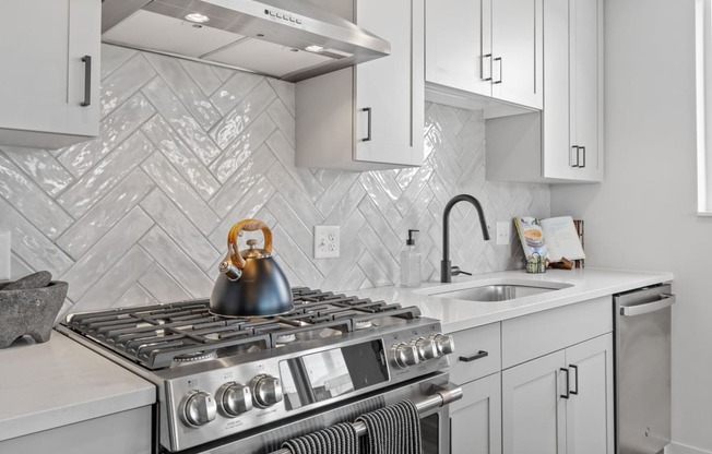 a kitchen with a stove and a sink