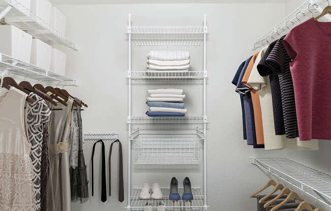 A walk in closet with wardrobe organizers at Colonial Pointe at Fairview Apartments, Bellevue, Nebraska