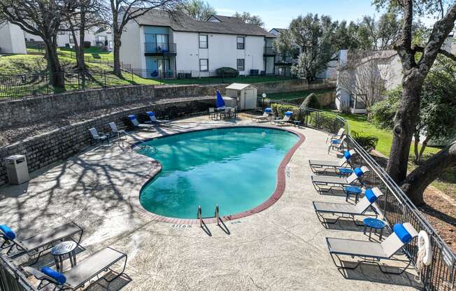 an aerial view of a swimming pool with lounge chairs around it  at Shadow Ridge, Arlington, 76013