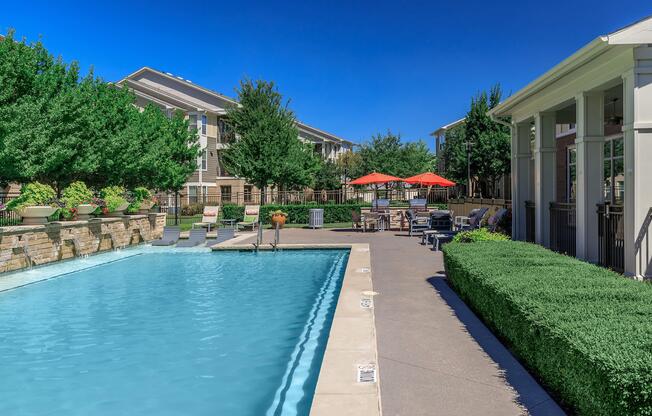 a house with a pool in front of a building