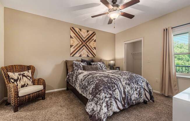 a bedroom with a bed and a ceiling fan