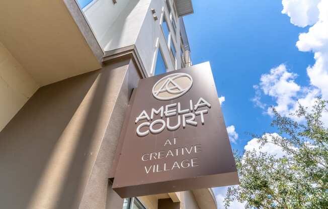 a sign for the amelia court at creative village is shown in front of a blue sky