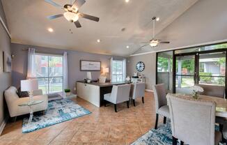 a living room filled with furniture and a large window