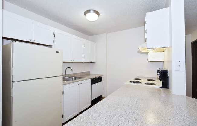 a kitchen with white cabinets and a white counter top