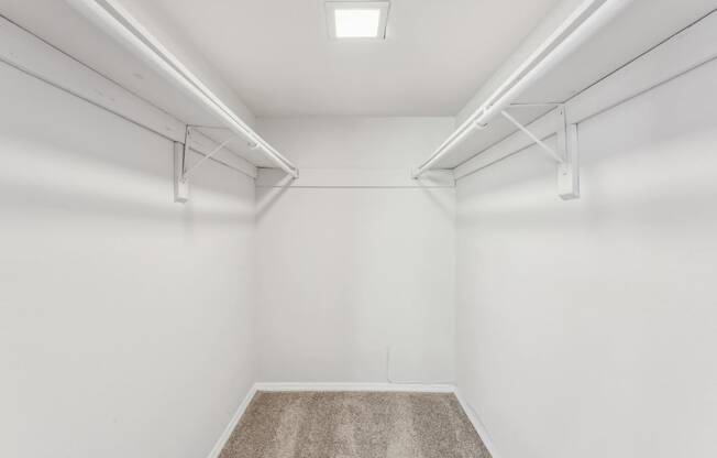 an empty room with white walls and a carpet