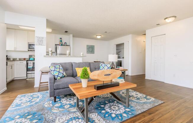 a living room filled with furniture and a wood floor