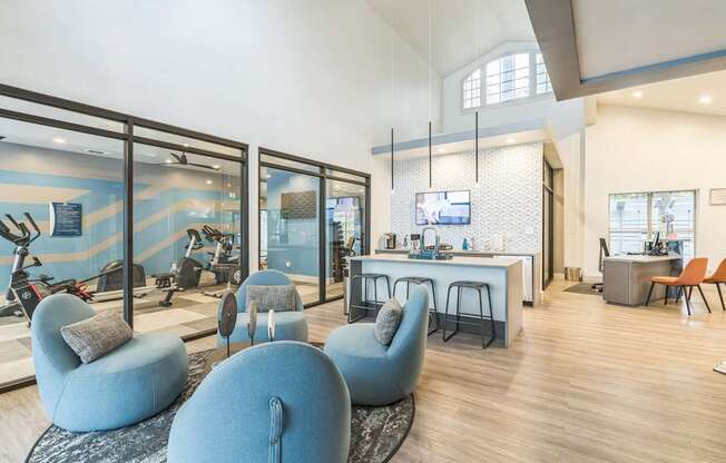 A modern living room with blue chairs and a white sofa.