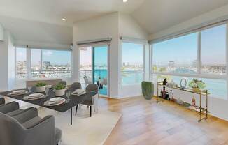 A dining room with a table set for six with a view of the city at Esprit Marina del Rey, 90292