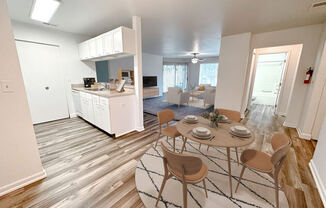 an open floor plan with a dining table and chairs