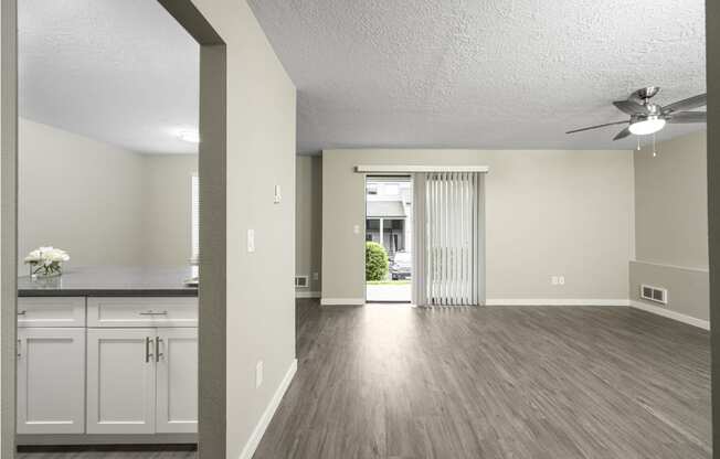 a living room and dining room with a ceiling fan