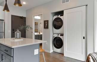 a kitchen with a washing machine and a dryer in it