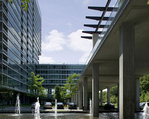A modern building with a fountain in front of it.