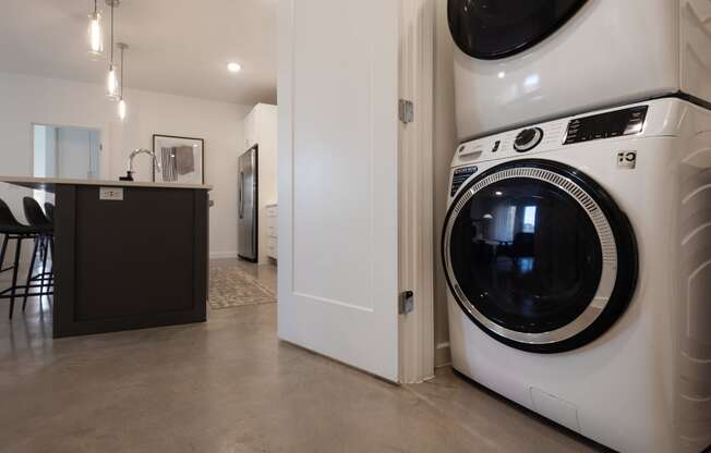 a front loading washer and dryer in a kitchen next to a laundry room