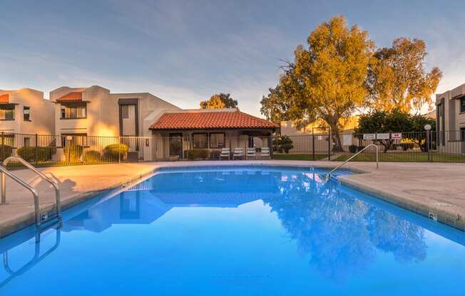 Riverstone pool view with nice view, and lounging area nearby