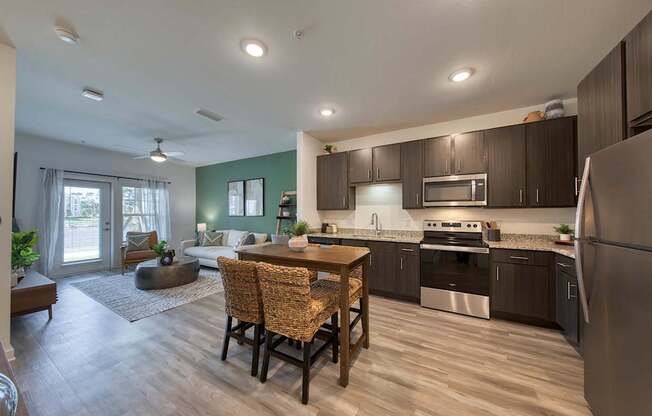 A kitchen with a table and chairs in the middle of the room.