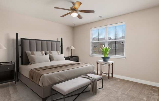 a bedroom with a bed and a ceiling fan