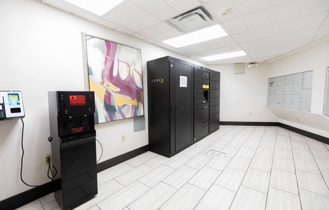 a room with black lockers and a machine on the floor