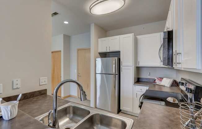 a kitchen with stainless steel appliances and a sink