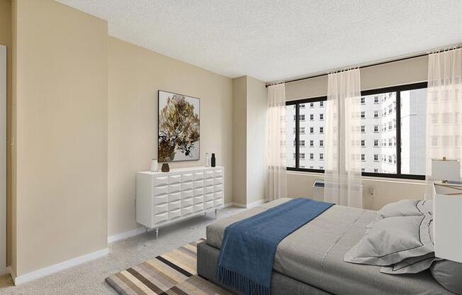 Modern bedroom with closet, queen sized bed, and carpet at Prospect Place 07601