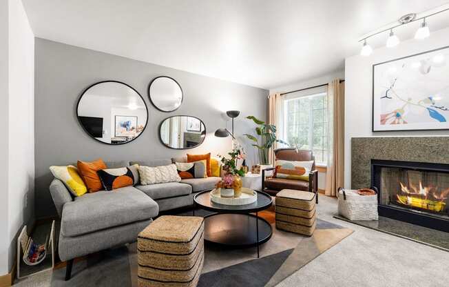 a living room with a gray couch and a fireplace