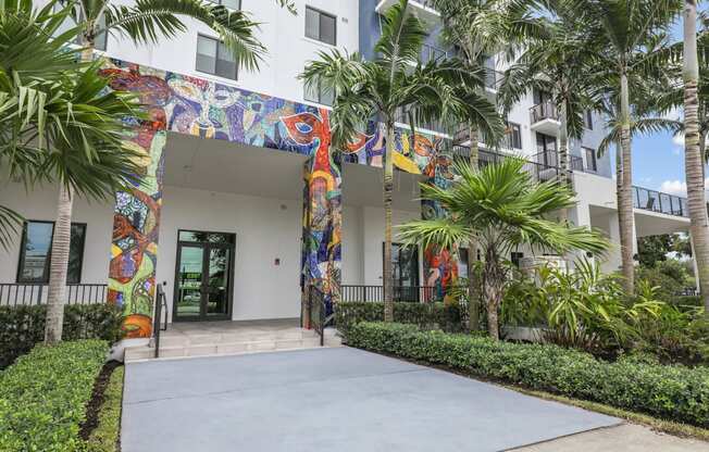 One of the entrances to our community with mural designs and palm trees at Bay Village 1 in Palmetto Bay, FL
