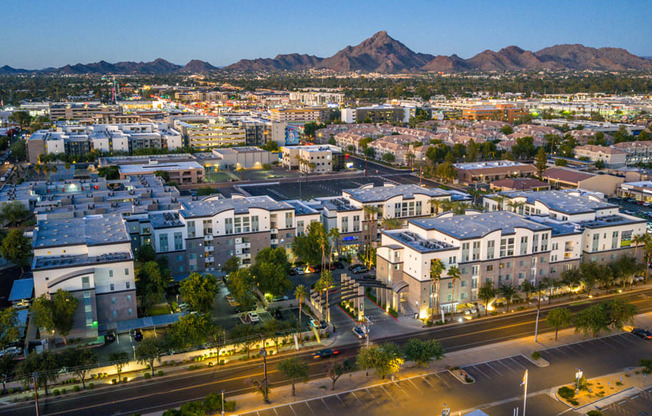 A cityscape with buildings and a mountain in the background.