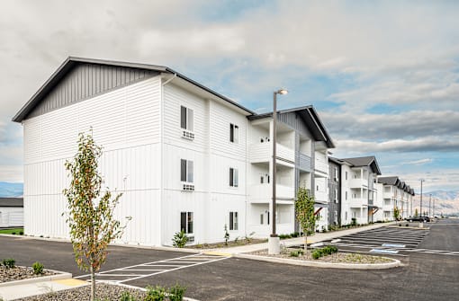 White apartment buildings with a parking lot at Gateway Apartments, East Wenatchee , WA 98802