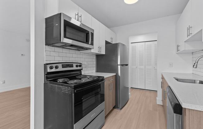 the interior of a kitchen with a stove and a microwave