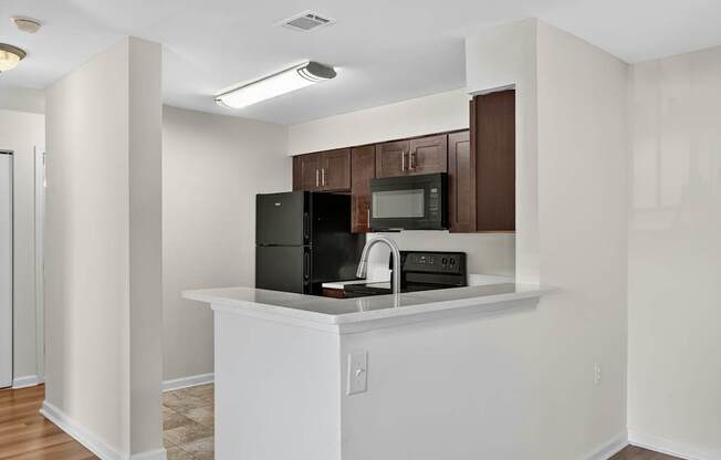 A kitchen with white cabinets and appliances.