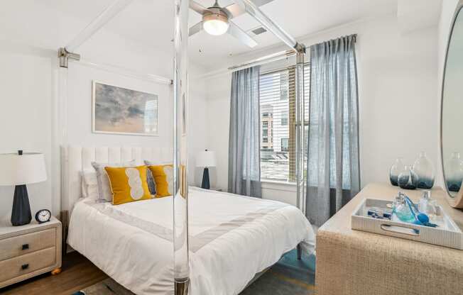 a bedroom with a white bed and a large window at Link Apartments® Mint Street, North Carolina, 28203