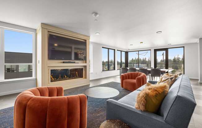 a living room with a fireplace and large windows at Ion Town Center, Shoreline, WA