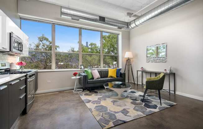 a living room with a large window and a couch and a table