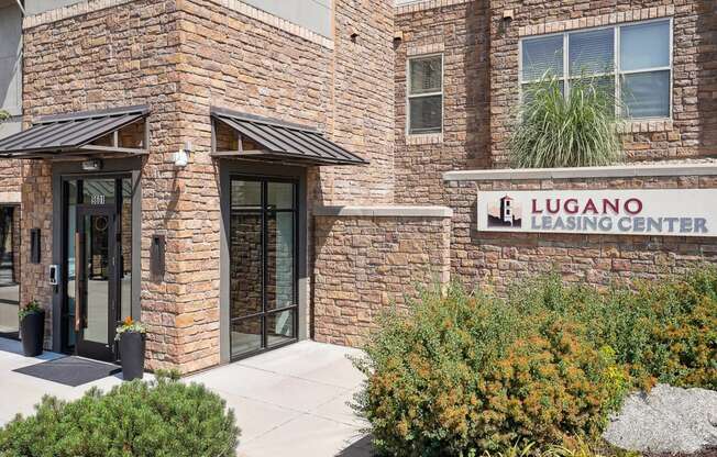 a brick building with a sign leasing center