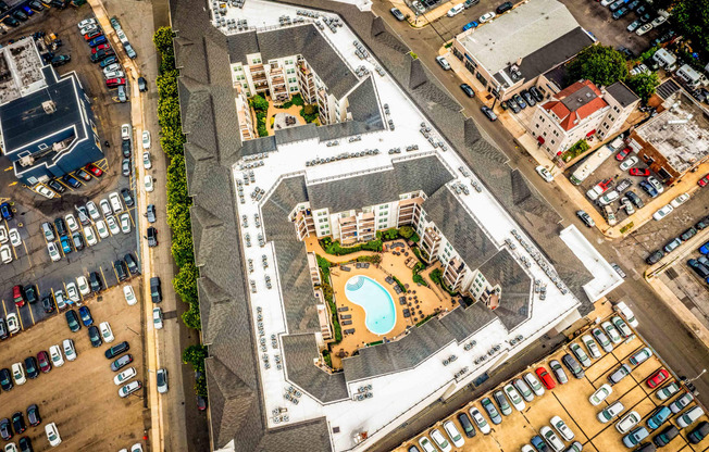 an aerial view of an apartment complex with a swimming pool and parking lot at Metro 303, Hempstead New York