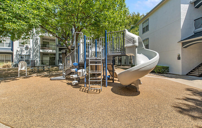 Community Playground with a Slide at Allure North Dallas Apartments in Dallas, TX.