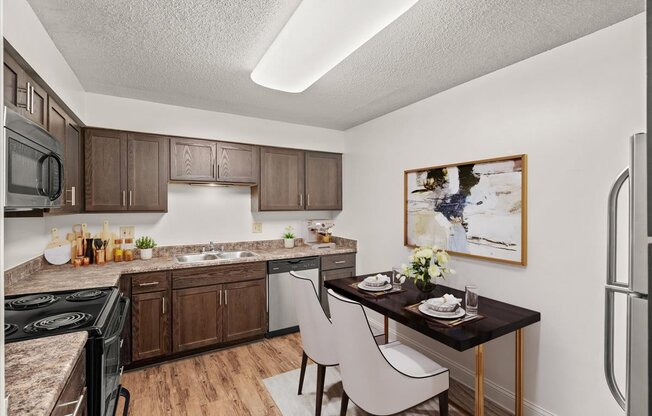our apartments offer a kitchen and dining area with a table