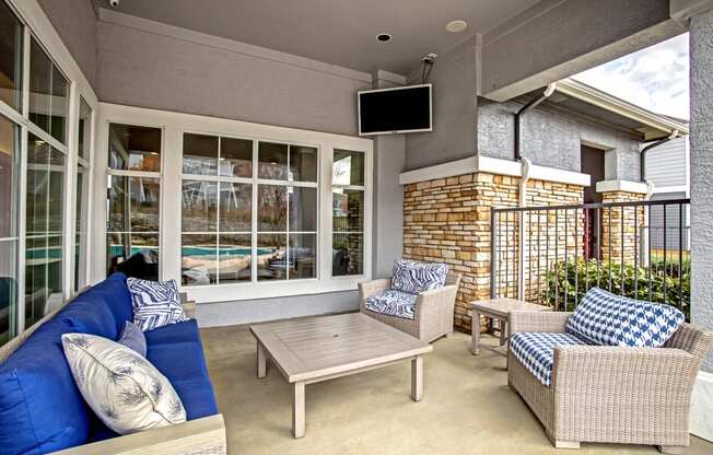 outdoor seating area with patio furniture and tv screen