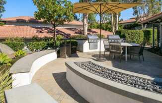 a patio with tables and chairs and a fountain