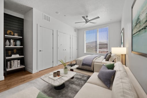 a living room with a couch and a ceiling fan  at SevenO2 Main Apartments, Salt Lake City