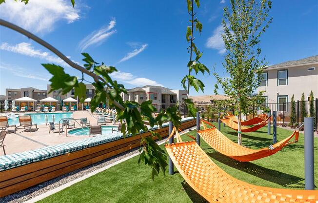 lawn with hammocks poolside at Lumina apartments