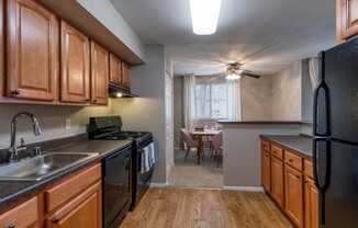 Designer Kitchens With, Wood Flooring, Sleek Black Appliances & Solid Wood Cabinets at The Brook At Columbia, Columbia, MD