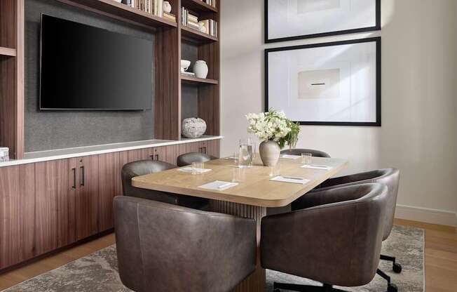 A modern dining room with a dark brown table and chairs.